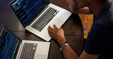 man sitting in front of the MacBook Pro